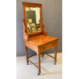 An Edwardian oak dressing table, with mirrored back, single drawer and raised on castors, 67 by 60