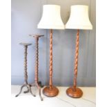 Two 19th century mahogany torchere's, together with a pair of barleytwist lamp standards.