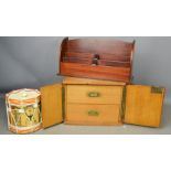 An oak two drawer cabinet enclosed with doors, a letter rack and a Seaforth Highlanders drum form