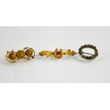 A 15ct sweetheart brooch, a gilt metal example and an oval form paste brooch.