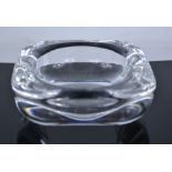 A Holmegaard glass ashtray, etched with signature to the base, 16cm diameter.