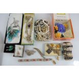 A quantity of costume jewellery including silver, brooches and other items.