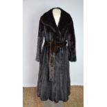 A full length mink coat and belt, in the original bag, size 10-12