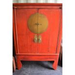 Two red lacquered Chinese cabinets with shelved interior and two drawers, 170cm high by 112cm by