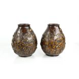 A pair of early 19th century Chinese / Japanese bronze vases cast with peonies and prunus blossom