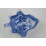 An early 19th century English blue and white Maple leaf form pottery dish depicting Chinese