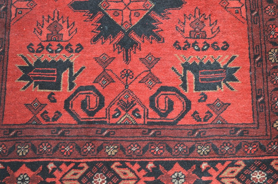 A red ground rug with Aztec design, 105cm by 142cm - Image 2 of 2