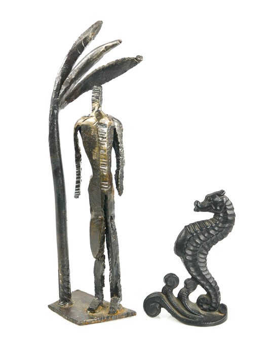 A cast iron door stop in the form of a seahorse, and a metal figurine, 36cm high