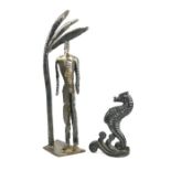 A cast iron door stop in the form of a seahorse, and a metal figurine, 36cm high
