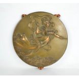 A Chinese bronze roundel plaque depicting female figure circa 1920, bearing embossed calligraphy