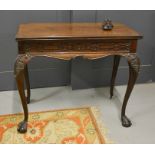 A 19th century mahogany Chippendale style card table, carved with blind fret work frieze, above