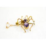 A 9ct gold spider brooch set with amethyst, 4.5cms x 3cms , 5.3g.