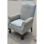 A Georgian style armchair with ball and claw feet with light blue upholstery