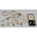 A group of jewellery to include a silver and marcasite brooch, silver bangles, pearl necklace etc