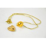 A 9ct gold heart form lock, 2.2g, and a silver gilt Flora Danica of Denmark nut pendant.