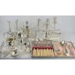 A group of silver plated items to include cutlery, toast rack, candelabra, tray etc