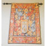 A tapestry French style wall hanging, on metal pole, depicting a crest, with shield surmounted by