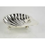 A sterling silver scallop design butter dish, with three ball feet to the bottom, Sheffield 1923,