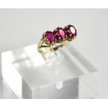 A 9ct white gold and pink tourmaline three stone ring, size O, 3.65g.