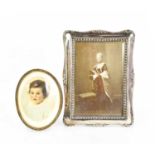 A silver Victorian photograph frame, together with an oval frame.Largest 19 by 13cm