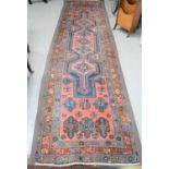 A long Middle Eastern wool runner, with stylized geometric motifs, 112cms x 400cms