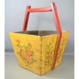 A 20th century Chinese wooden water carrier decorated with flowers62cm by 47cm