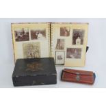 An Edwardian leather purse with silver clasp together with an album of Victorian and Edwardian