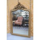 A large late 19th / early 20th century gold painted composition wall mirror with Rococo style