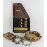 A vintage Autoharp, tambourine and further instrument