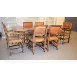 A set of six dining chairs with leather studded back and seats together with an oak drawleaf