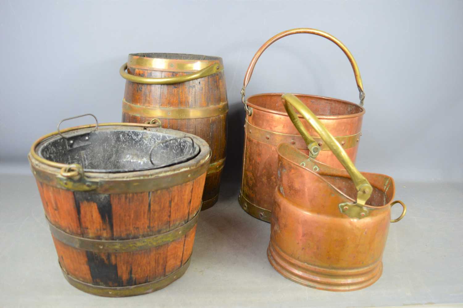 Two oak and brass coopered coal buckets together with two copper examples