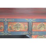 An early 20th century Tibetan handpainted elm cabinet with four drawers over four cupboards.166cm