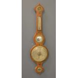 A George III inlaid mahogany wheel barometer ,swan neck pediment over a hygrometer and thermomet