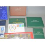 A quantity of British coins and medallic first day covers, some silver examples to include 100 years