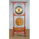 A 20th century handpainted elm wood Tibetan drum and gong stand171cm high by 80cm wide