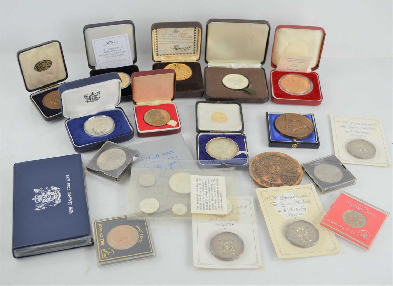 A group of commemorative coins and medallions to include John F Kennedy, Isle of Man five pounds,