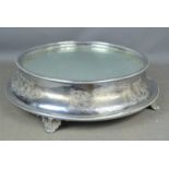 A silver plated cake stand with glass top rasied on bracket feet12cm high by 36cm diameter