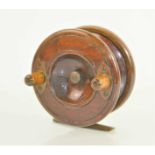 An early 20th century wood and brass starback centrepin fishing reel