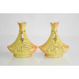 A pair of Locke & Co Worcester porcelain blush ivory vases, the tapered bodies pierced with