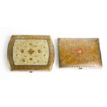 Two Indonesian metalware cigarette cases, with intricate floral designs and coloured highlights.