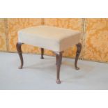 A Queen Anne style walnut stool, with cream velour upholstered top