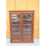 An Edwardian mahogany display cabinet with two glazed doors enclosing shelves137cm high by 104cm