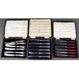 Two sets of silver handled butter knives, together with a vintage set with red handles, all boxed.