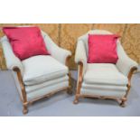 A pair of french walnut framed armchairs, linen upholstered, feather cushions.
