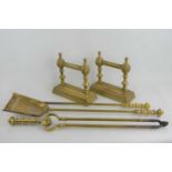 A three piece brass fire companion set and a pair of matching fire dogs.