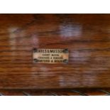 A Victorian oak dining table with original winder and one extra leaf, made by Coates and Musson