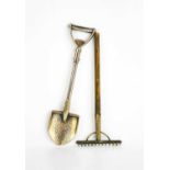 A novelty spade and rake, the silver plated spade cast with detail, and the 800 grade silver rake