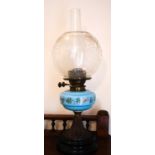 A Victorian paraffin lamp with blue glass centre painted with flowers and clear glass etched