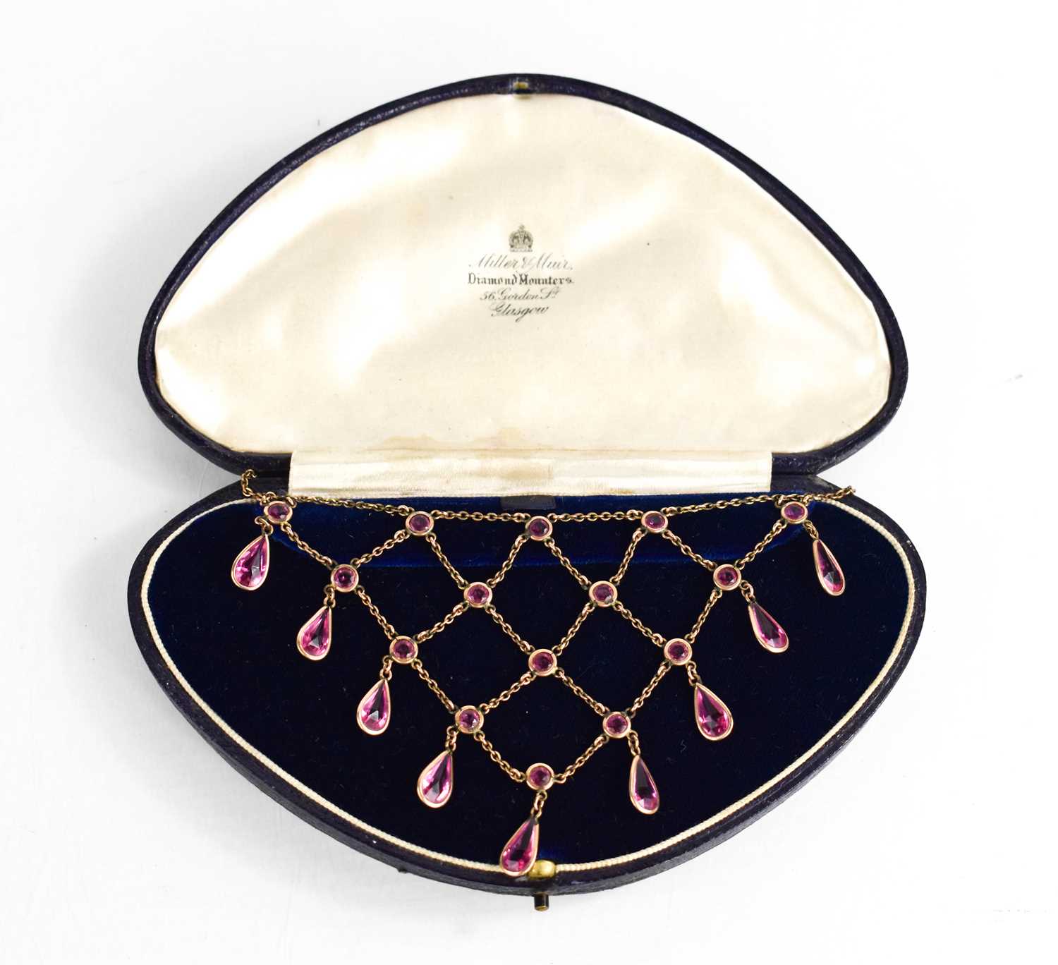 A vintage waterfall necklace, set with pink paste stones, in a presentation box labelled Miller &