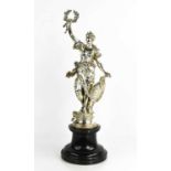 A German silver figure of a woman holding a laurel wreath aloft, and standing beside a rococco